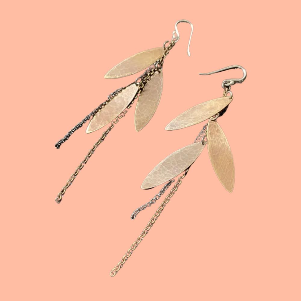 A pair of feather brass earrings with chains made by Jennifer Kahn