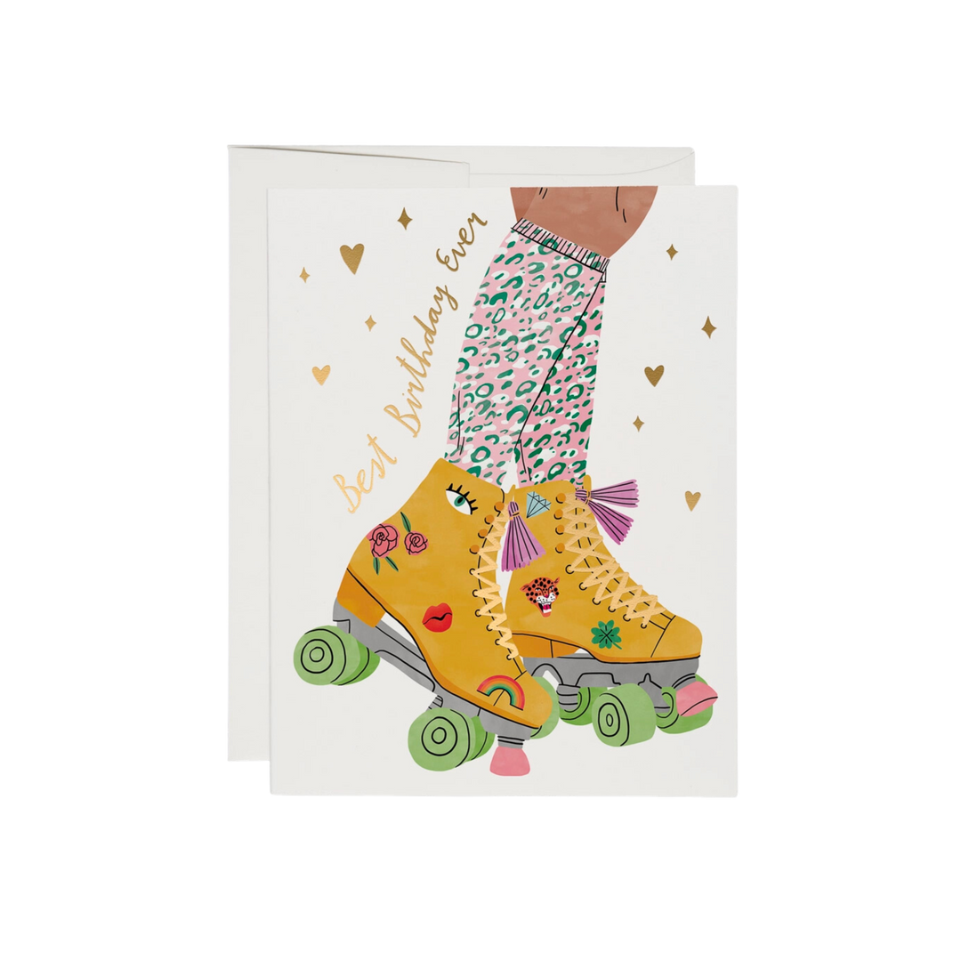 Illustrated yellow rollerskates with pink and teal cheetah print socks, gold text says "Best Birthday Ever". This Roller Skate Birthday Card features 100lb heavyweight card stock, offset printing, and foil stamping. At 5.5 x 4.25 inches, illustrated by Bodil Jane, it is printed in the USA using recycled paper and is blank inside.