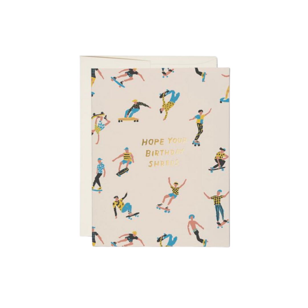 Cartoon people on skateboards with gold text reading "Hope Your Birthday Shreds". Blank inside. 100lb heavyweight card stock. Offset printed and foil stamped. 4.25 x 5.5 inches. Illustrated by Danielle Kroll. Printed in USA, on recycled paper.