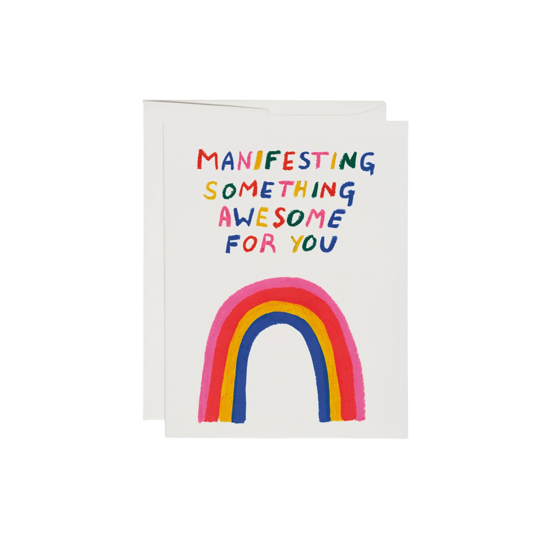 Illustrated rainbow with rainbow colored text reading "Manifesting Something Awesome For You". This Something Awesome Encouragement Card has a blank interior, is printed on 100lb heavyweight card stock, and features an offset printed design. At 5.5 x 4.25 inches, it is illustrated by Katie Benn and printed in the USA on recycled paper.