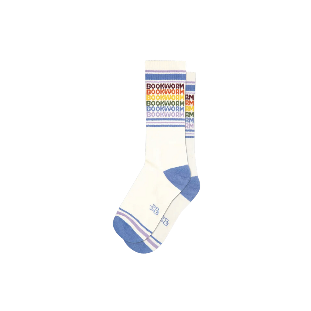 White socks with blue stripes and rainbow text "Bookworm" repeated six times. Crafted with a Cotton/Nylon/Spandex blend, this unisex, one size fits most pair of socks is designed to keep you comfortable through any journey, be it real or imaginary. Crafted in the USA, these socks will ensure your toes stay cosy.