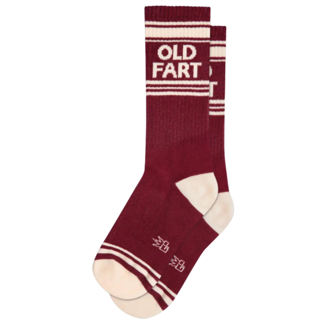 Maroon socks with white stripes and text "Old Fart". Not a day over magnificent? Sport some Werther's Original confection, plus these outrageous show-stoppers crafted from a comfy blend of 61% cotton, 36% nylon, and 3% spandex awesomeness. A proud single-size, made in USA, fit for a true OLD FART!
