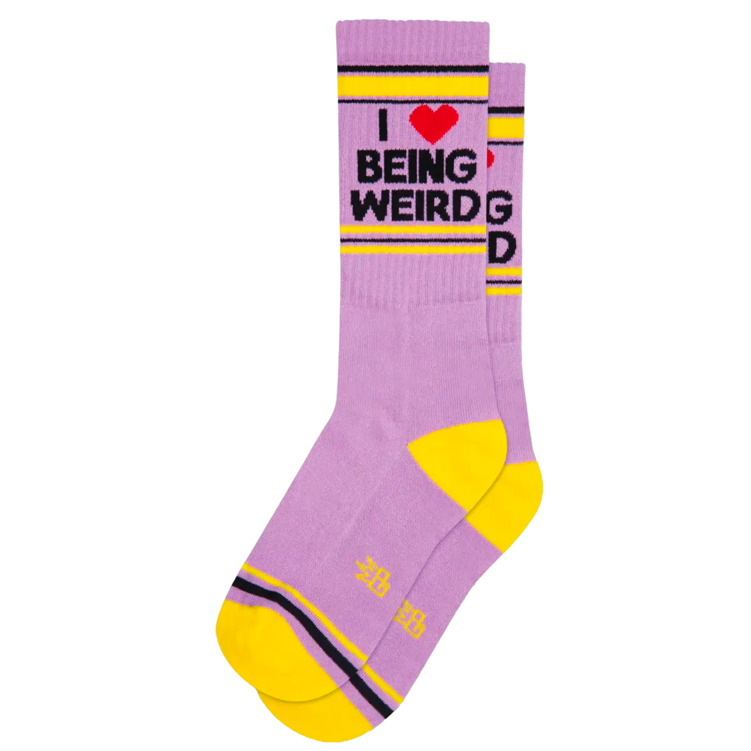 Purple with black and yellow stripes and text "I Love Being Weird". Let these socks help you show your unique style and individuality! Crafted from a Cotton/Nylon/Spandex blend and made in the USA, these unisex socks come in one size which fits most. Show off your creative side with these I Love Being Weird Gym Socks!
